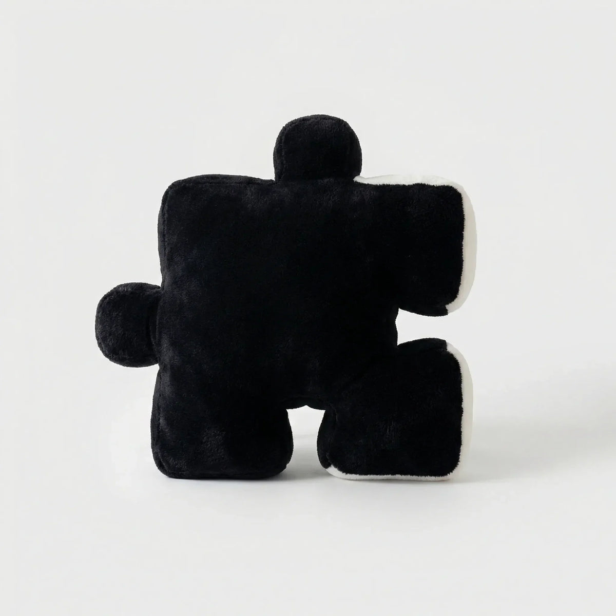 Puzzle-Shaped Cushion in Modern Black and White Design